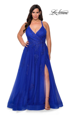 A woman wearing the La Femme Long Prom Dress 29021 in royal blue, a floor-length formal gown featuring floral embroidery, a deep V-neckline, spaghetti straps, and a thigh-high slit. The La Femme logo appears in the top right corner.