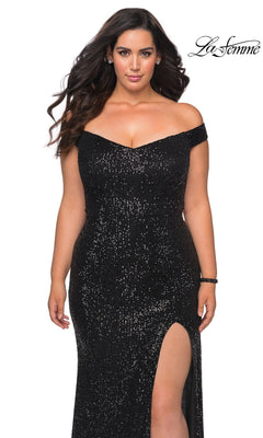 A plus-size woman wears the Long Plus-Size Prom Dress: La Femme 29023, an off-the-shoulder, black sequin floor-length gown with a high side slit.