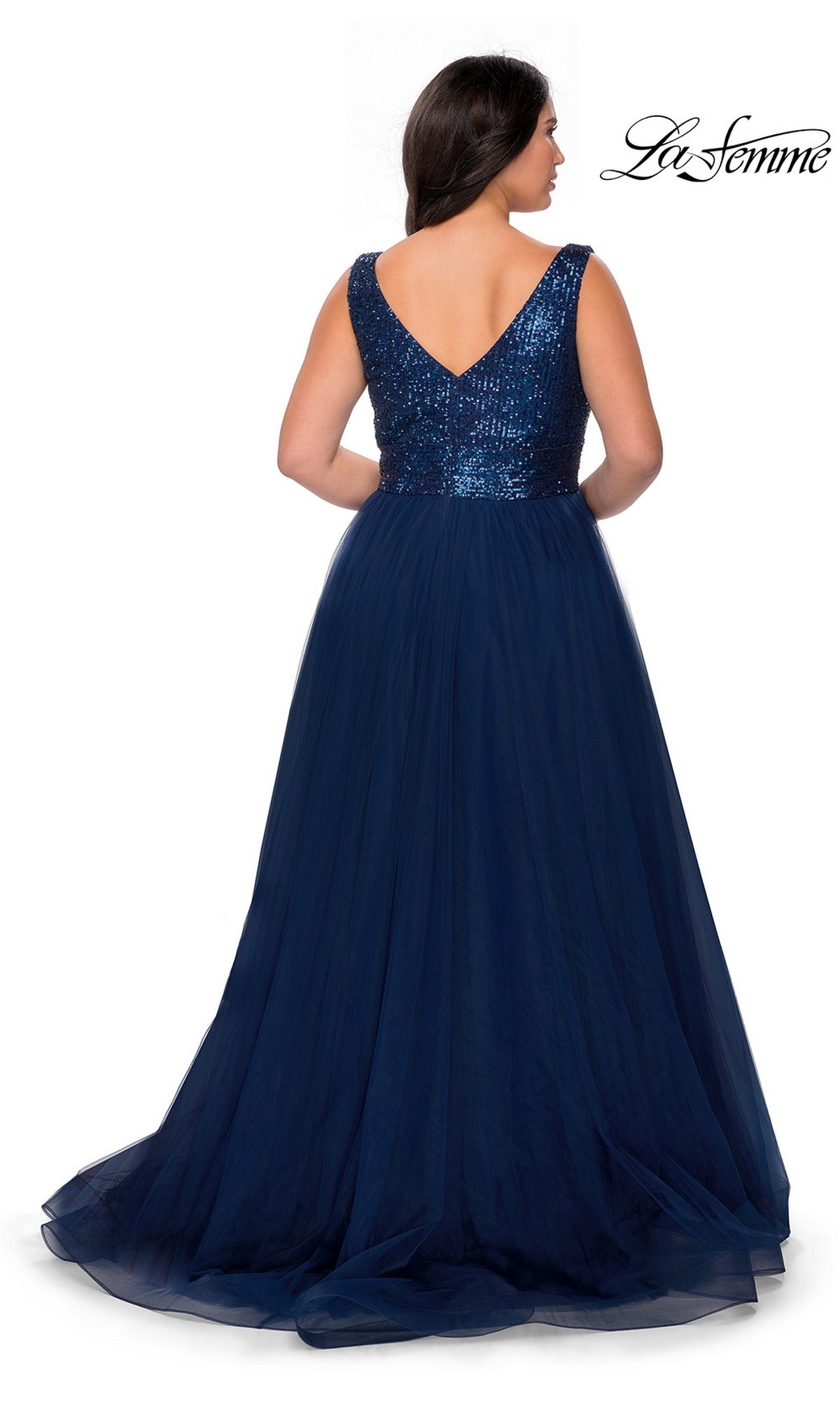 A woman is shown from the back in the Long Plus-Size Prom Dress: La Femme 29045, featuring a navy sequin bodice, tulle A-line skirt, V-shaped back, and sleeveless design.