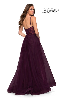 Woman facing away in a floor-length La Femme Sheer-Waist Long A-Line Prom Dress 29076, deep purple with spaghetti straps, low back, fitted bodice, and tulle overlay.