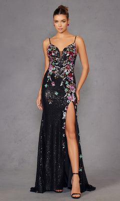 A woman poses elegantly in the Long Black Sequin Floral Prom Gown Juliet JT2909K, featuring multicolored embroidery, spaghetti straps, a deep v-neckline, and a high slit against a gray background.