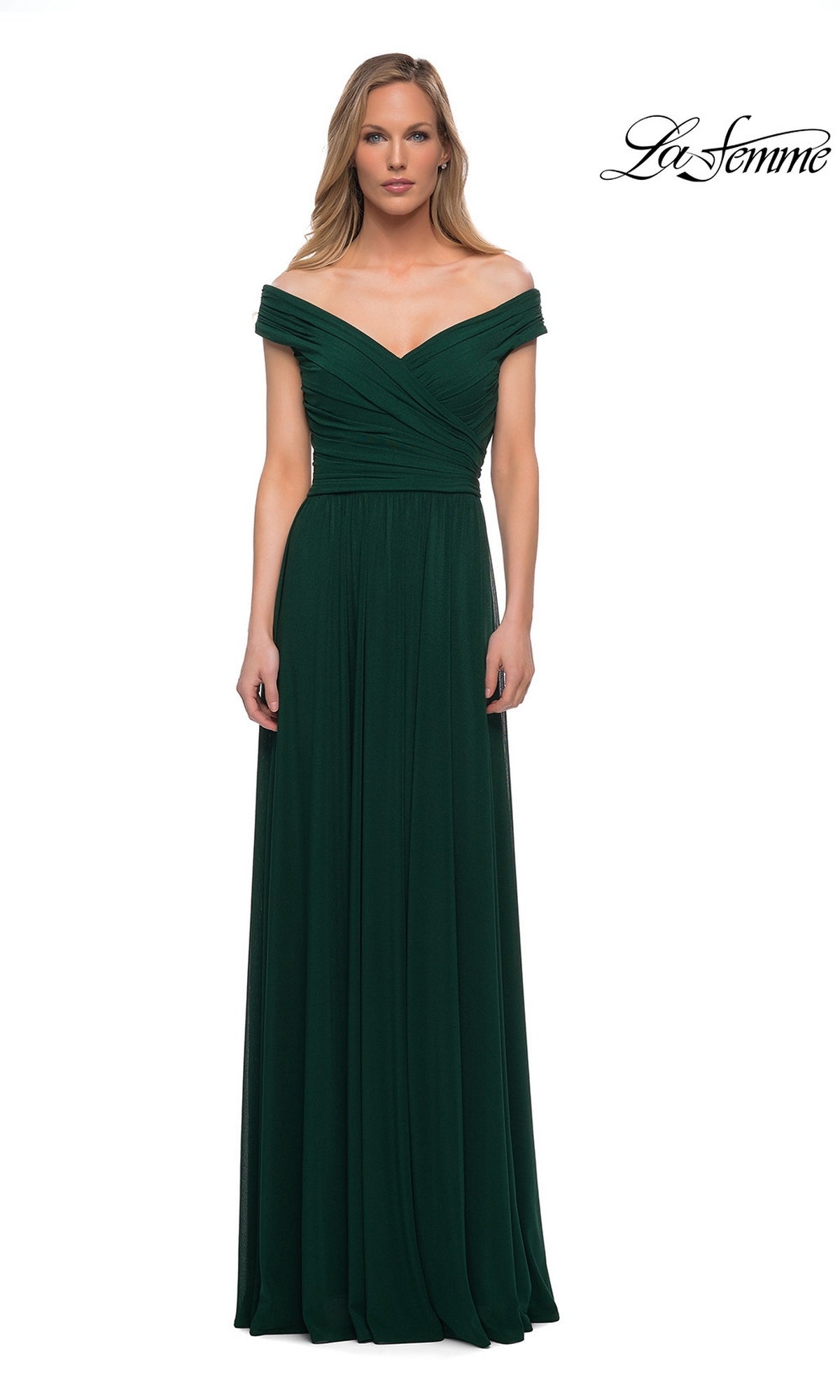 A woman wears the Long Formal Dress: La Femme 29168 in emerald, featuring an off-the-shoulder fitted bodice and A-line floor-length skirt. “La Femme” logo appears at top right.