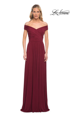 A woman wears the Long Formal Dress: La Femme 29168 in wine, featuring an off-the-shoulder ruched bodice and A-line skirt. The La Femme logo appears top right.
