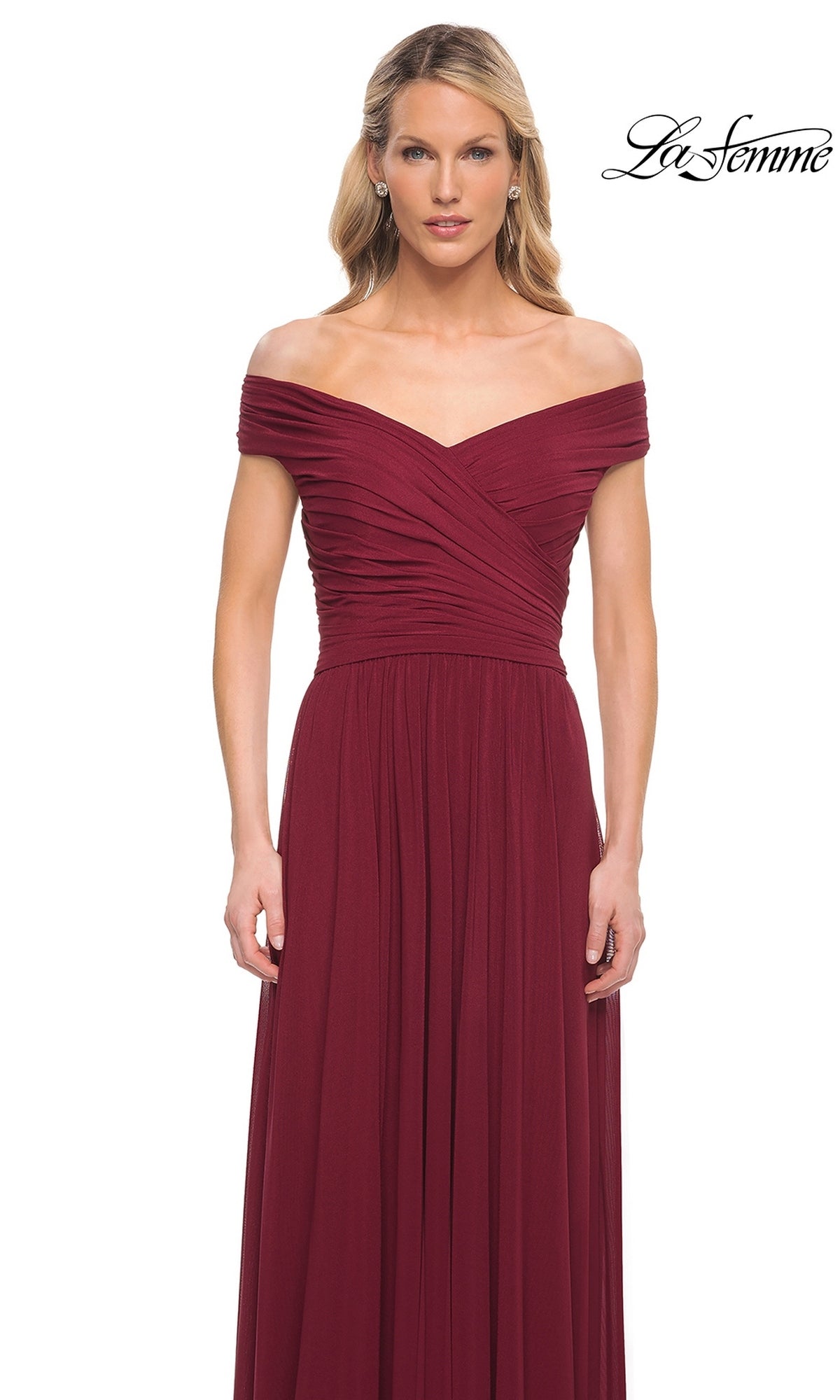 Woman wears Long Formal Dress: La Femme 29168—an off-the-shoulder, floor-length burgundy gown with ruched bodice and A-line skirt—against a white background.
