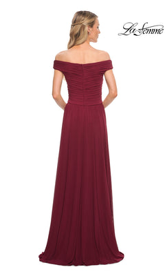 Woman in Long Formal Dress: La Femme 29168—an off-the-shoulder, floor-length burgundy gown with ruched detailing, A-line skirt, and zipper closure, seen from the back.