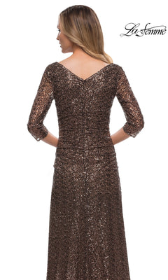 Woman wearing Long Formal Dress: La Femme 29195—a brown sequin gown with three-quarter sleeves and V-back—faces away; “La Femme” logo is in the top right.