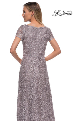Back view of a woman wearing a La Femme 29198, a short-sleeved, floor-length dark mauve lace formal dress with intricate embroidery.