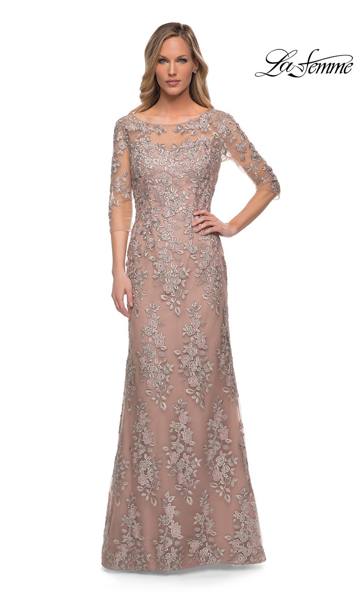 Woman in the Long Formal Dress: La Femme 29225, a floor-length champagne gown with silver floral embroidery and sheer three-quarter sleeves. “La Femme” logo top right.