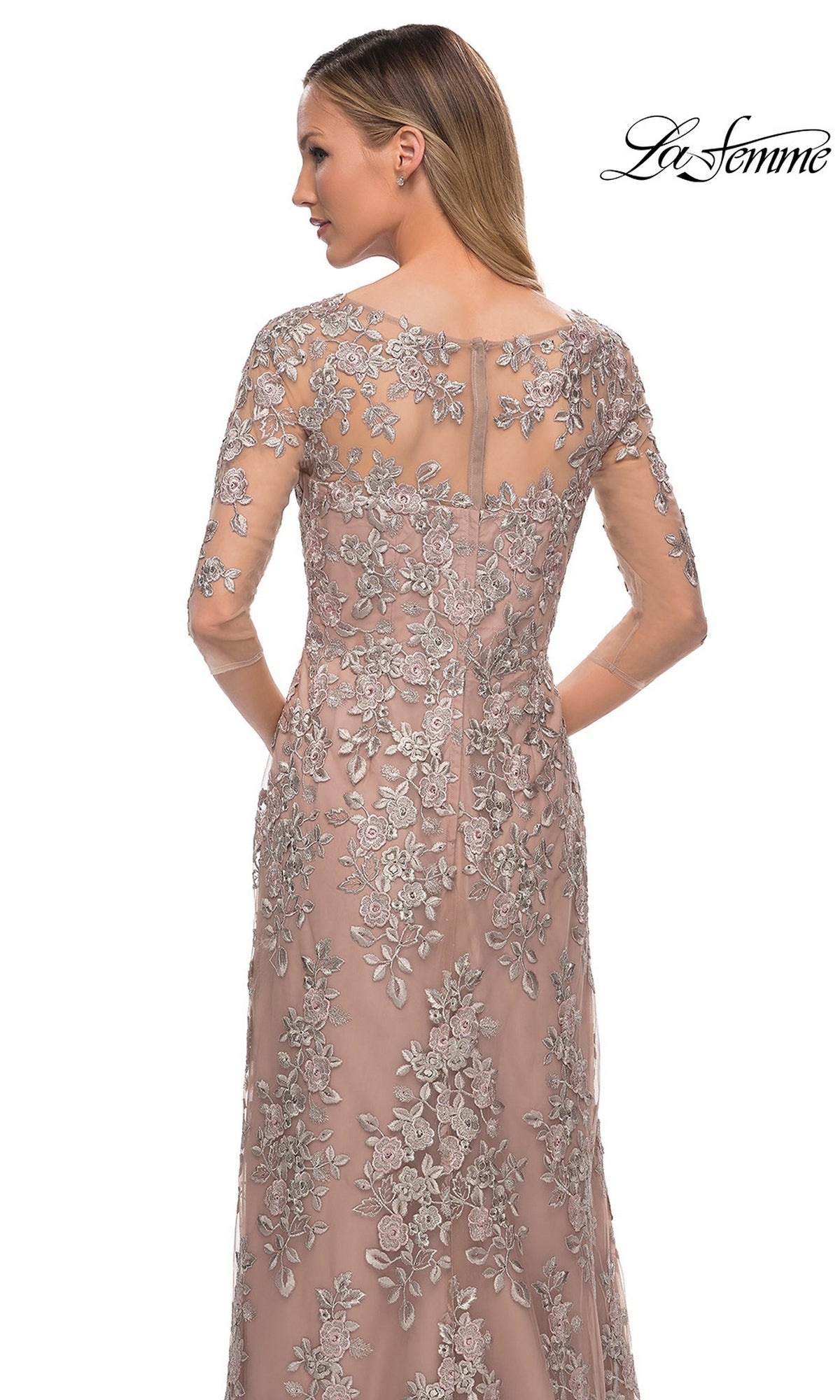 Woman wearing Long Formal Dress: La Femme 29225, a mauve sheath with silver floral embroidery and sheer sleeves; “La Femme” logo in the top right.