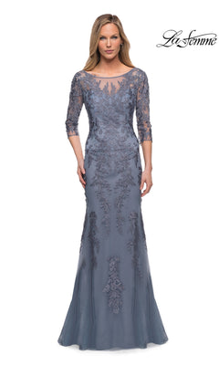 Woman wearing the Long Formal Dress: La Femme 29226, a floor-length slate blue gown with lace embroidery, sheer three-quarter sleeves, and floral detailing.