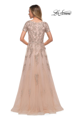 Woman faces away in the floor-length, short-sleeve pink tulle Long Formal Dress: La Femme 29290 with floral embroidery and metallic lace appliques; “La Femme” logo top right.