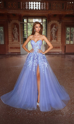 A woman in the Strapless Glitter Prom Ball Gown: Aerie Couture 293 stands in an ornate hall with statues and large windows.