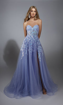 A woman in the Strapless Glitter Prom Ball Gown: Aerie Couture 293 stands against a plain gray background, showcasing its lavender hue with floral lace embroidery and a sheer overlay.
