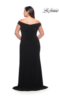 Back view of a black, plus-size Long Plus-Size Prom Dress: La Femme 29474 in matte jersey, featuring floor-length styling and gathered fabric along the center back.