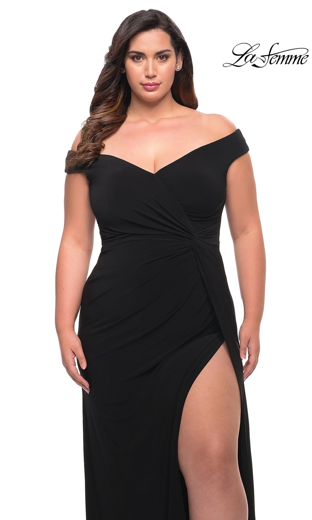 A woman wearing a La Femme 29474 off-the-shoulder black matte jersey evening gown with a high side slit.