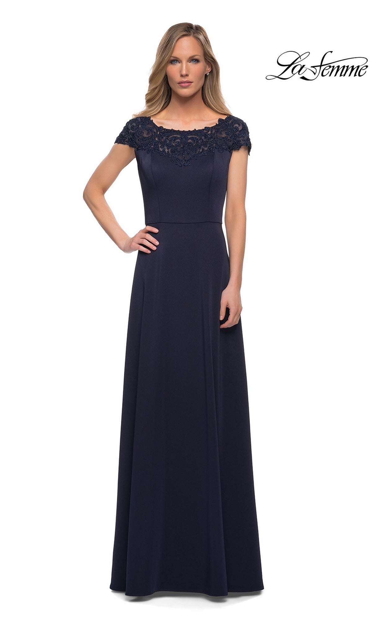 Woman wearing the Long Formal Dress: La Femme 29511, a floor-length navy gown with a lace bateau neckline and A-line skirt, against a white background.