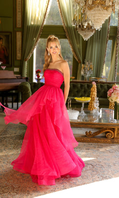 A woman in the Ava Presley 29524 strapless long prom ball gown poses in an elegant room with green walls, chandeliers, and large windows.