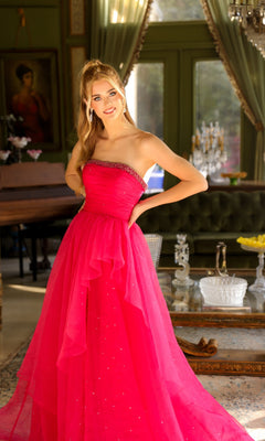 A woman in the Ava Presley 29524 strapless long prom ball gown stands in an elegant room with large windows, green walls, and a chandelier.