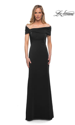 A woman models the Long Formal Dress: La Femme 29537—a floor-length, off-the-shoulder black fitted sheath gown with short sleeves—standing against a white backdrop featuring the “La Femme” logo in the top right corner. This minimalist chic design offers an effortlessly elegant look.