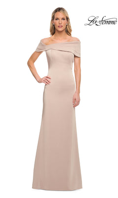 A woman stands facing forward against a white background, wearing the La Femme 29537 long formal dress—a fitted, off-the-shoulder, floor-length sheath gown in a chic champagne hue. Minimalist and timelessly elegant, this dress is perfect for special occasions. The La Femme logo appears in the top right corner.