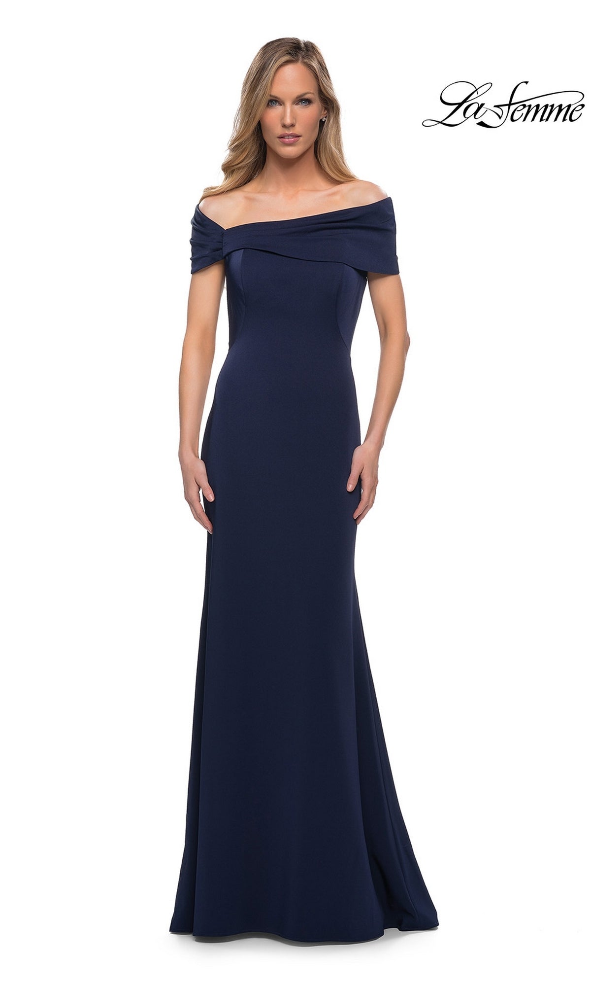 A woman models the La Femme 29537 long formal dress in navy, a floor-length, off-the-shoulder fitted sheath gown, standing against a white background with the La Femme logo in the top right corner.