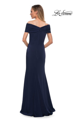 A woman with long, straight hair is seen from the back wearing the Long Formal Dress: La Femme 29537, a floor-length, off-the-shoulder navy blue fitted sheath gown featuring a slight train. The La Femme logo appears in the upper right corner.
