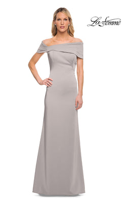A woman stands facing forward, wearing the La Femme 29537 long formal dress in silver. The off-the-shoulder, floor-length minimalist chic gown is fitted through the bodice with a subtle flare at the bottom. The “La Femme” logo appears in the top right corner.