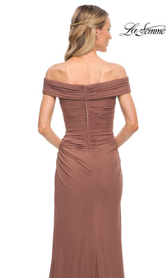 Woman wearing Long Formal Dress: La Femme 29541—an off-the-shoulder brown gown with ruched fitted bodice, wavy blonde hair, white background, “La Femme” logo top right.