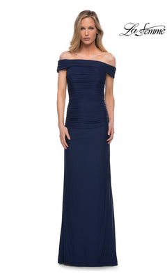 Woman in a navy Long Formal Dress: La Femme 29541 with a ruched fitted bodice, off-the-shoulder neckline, floor-length skirt. La Femme logo appears top right.