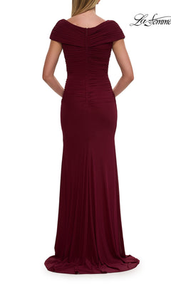 A woman is shown from the back wearing the La Femme 29558 cap-sleeve long formal dress, a floor-length burgundy evening gown with off-the-shoulder styling and ruched detailing.