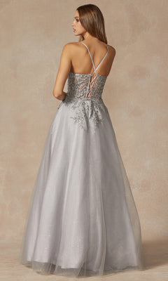 A woman models the Juliet 295 Lace-Up Long A-Line Prom Dress, featuring crisscross straps and embroidered floral designs, against a neutral background.