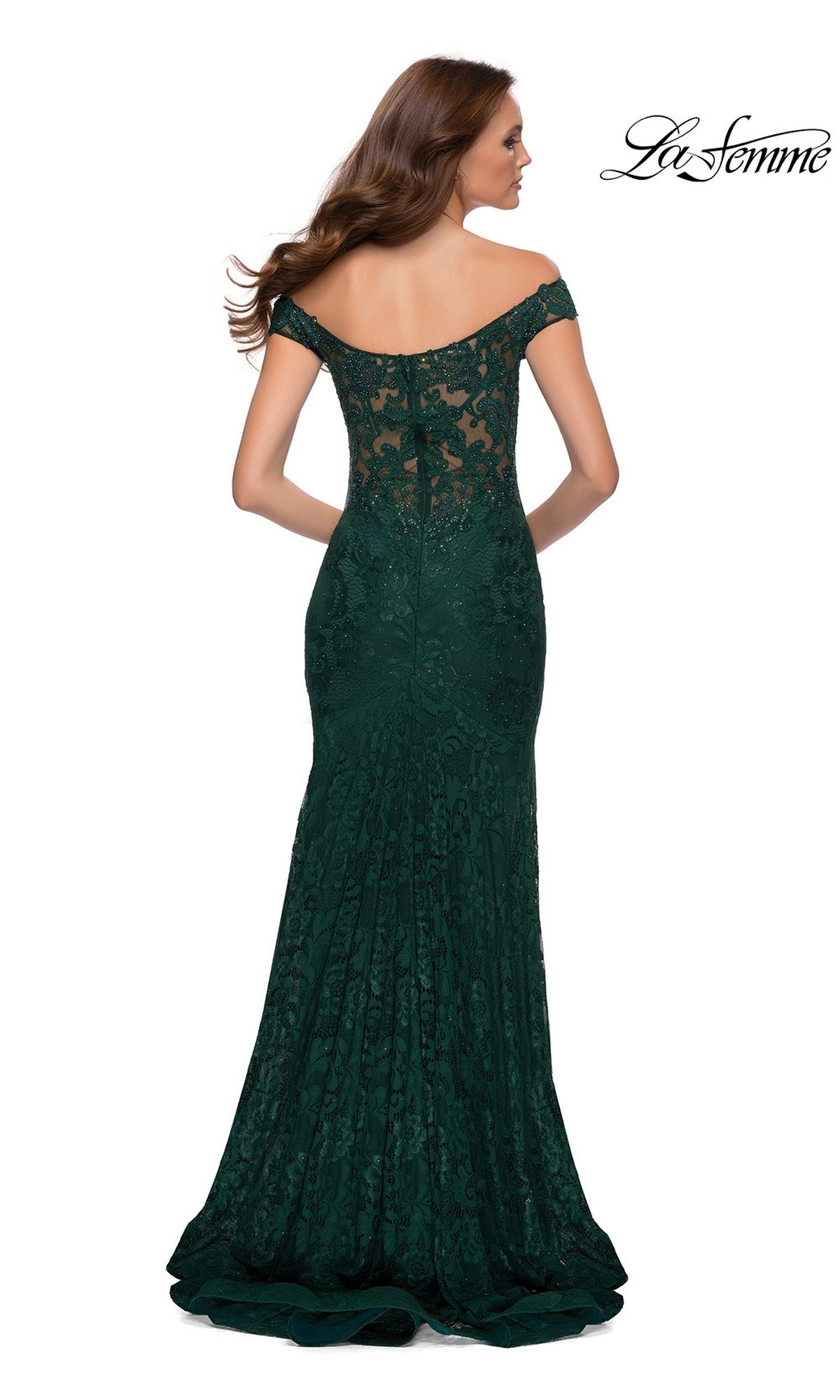 A woman faces away in the Long Prom Dress: La Femme 29693, a dark green stretch-lace gown with an off-shoulder neckline, low back, and floor-length train.