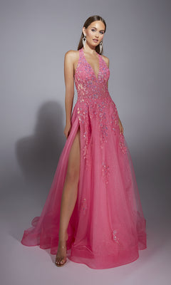 A woman poses against a plain gray background wearing the Long Halter Prom Dress: Aerie Couture 296—a pink, sparkly gown with floral embellishments, lace embroidery, a deep V neckline, and a high slit.
