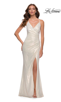 A woman stands against a plain white background wearing the La Femme Long White Metallic Prom Dress 29707, a floor-length gown featuring spaghetti straps and a thigh-high slit.