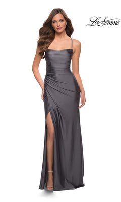 A woman wears the La Femme Square-Neck Long Prom Dress 29710 in dark gray, featuring a floor-length design, sleeveless cut, thigh-high slit, and ruched bodice, standing against a white background with the "La Femme" logo in the top right.