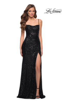 A woman wears the La Femme Long Prom Dress 29741 in black, featuring sequins, spaghetti straps, and a thigh-high slit. She poses against a plain white background with the "La Femme" logo in the top right corner.