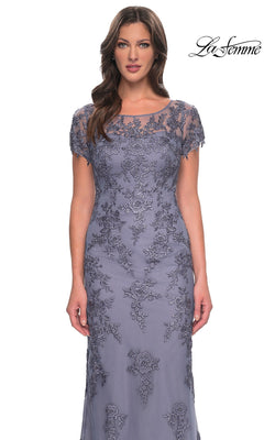 A woman wearing a slate gray, modest floor-length Long Formal Dress: La Femme 29792 featuring a sheer neckline, short sleeves, and floral embroidery.