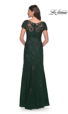 Back view of a woman in a Long Formal Dress: La Femme 29792, a modest, floor-length dark green gown with cap sleeves and intricate beadwork embroidery on the bodice and skirt.