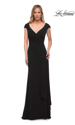 A woman wears a black La Femme 29814 long formal dress featuring cap sleeves, a V-neckline, and a gathered waist.