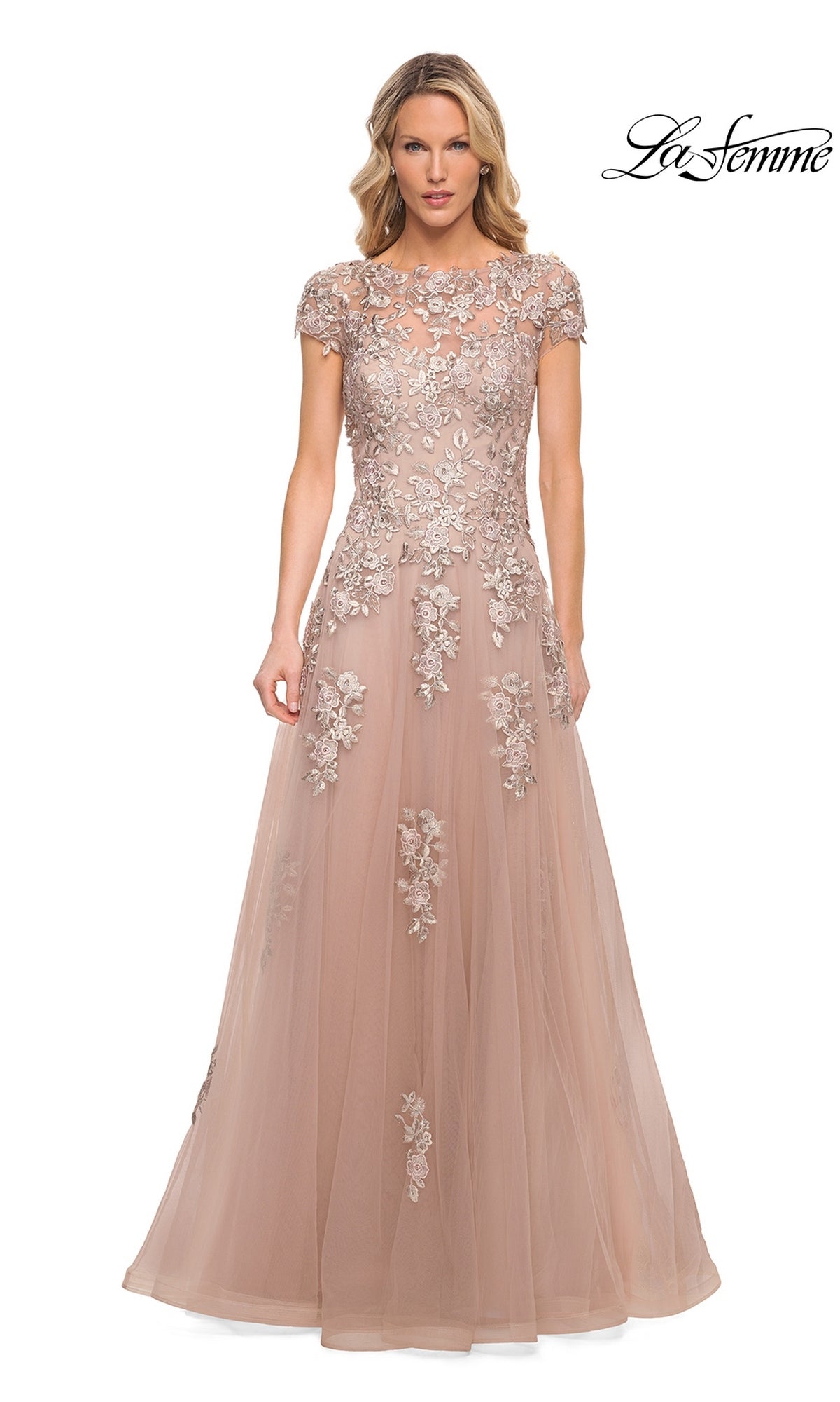 La Femme 29829 is a floor-length, blush formal dress with cap sleeves and silver lace appliques detailing the bodice and skirt.