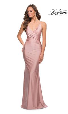 Woman wearing a sleeveless, floor-length blush pink La Femme Long Prom Dress 29848 with a V-neckline and fitted silhouette; "La Femme" logo in the top right corner.