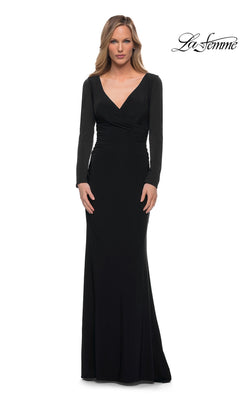 A woman wears a black La Femme 29924 floor-length jersey dress with a V-neckline and a ruched bodice.