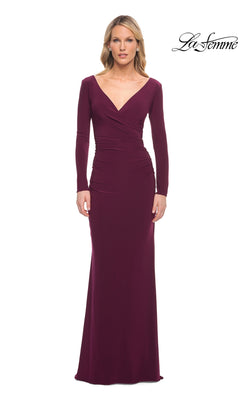 A woman wearing a dark berry La Femme 29924 long formal dress featuring a V-neckline and a ruched, wrapped bodice.