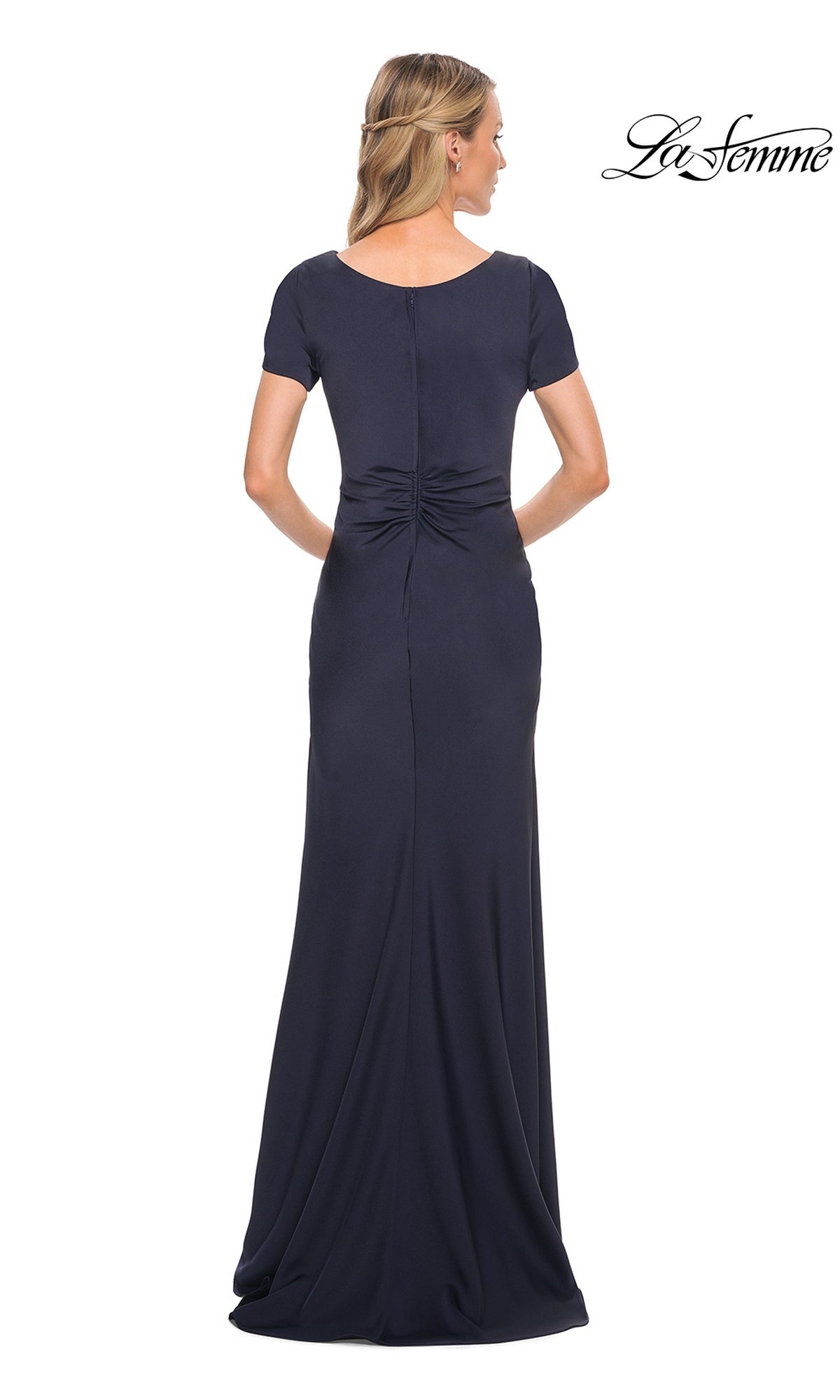 Back view of a woman wearing a La Femme 29926 floor-length navy blue modest formal dress with short sleeves and a gathered detail at the lower back.