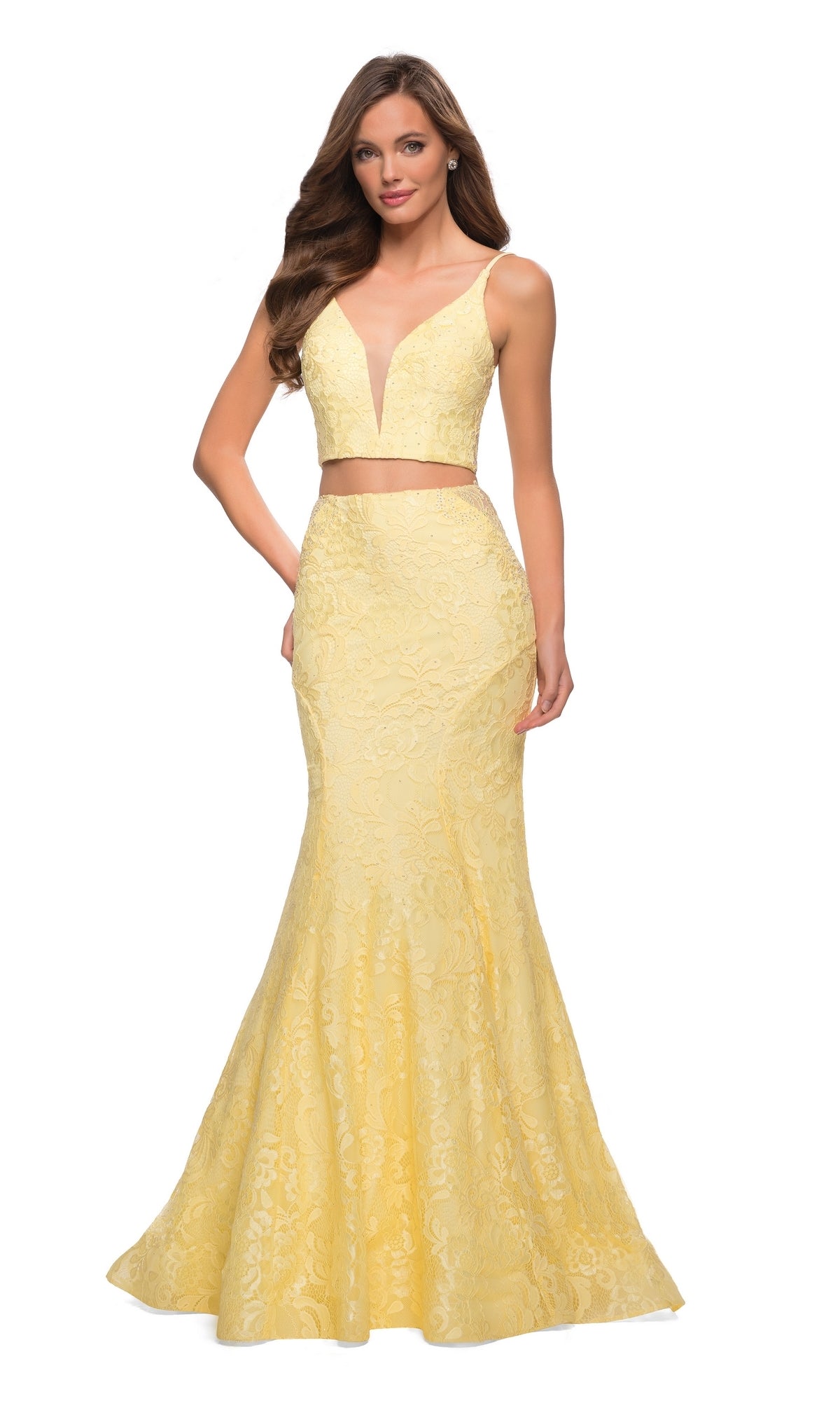 A woman wears La Femme 29970, a two-piece lace mermaid prom dress featuring a sleeveless, floor-length yellow design with a V-neckline and fitted silhouette.