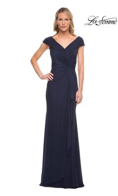 A woman wears a navy Long Formal Dress: La Femme 29996, a floor-length formal gown with a v-neckline, cap sleeves, and draped detailing at the bodice.