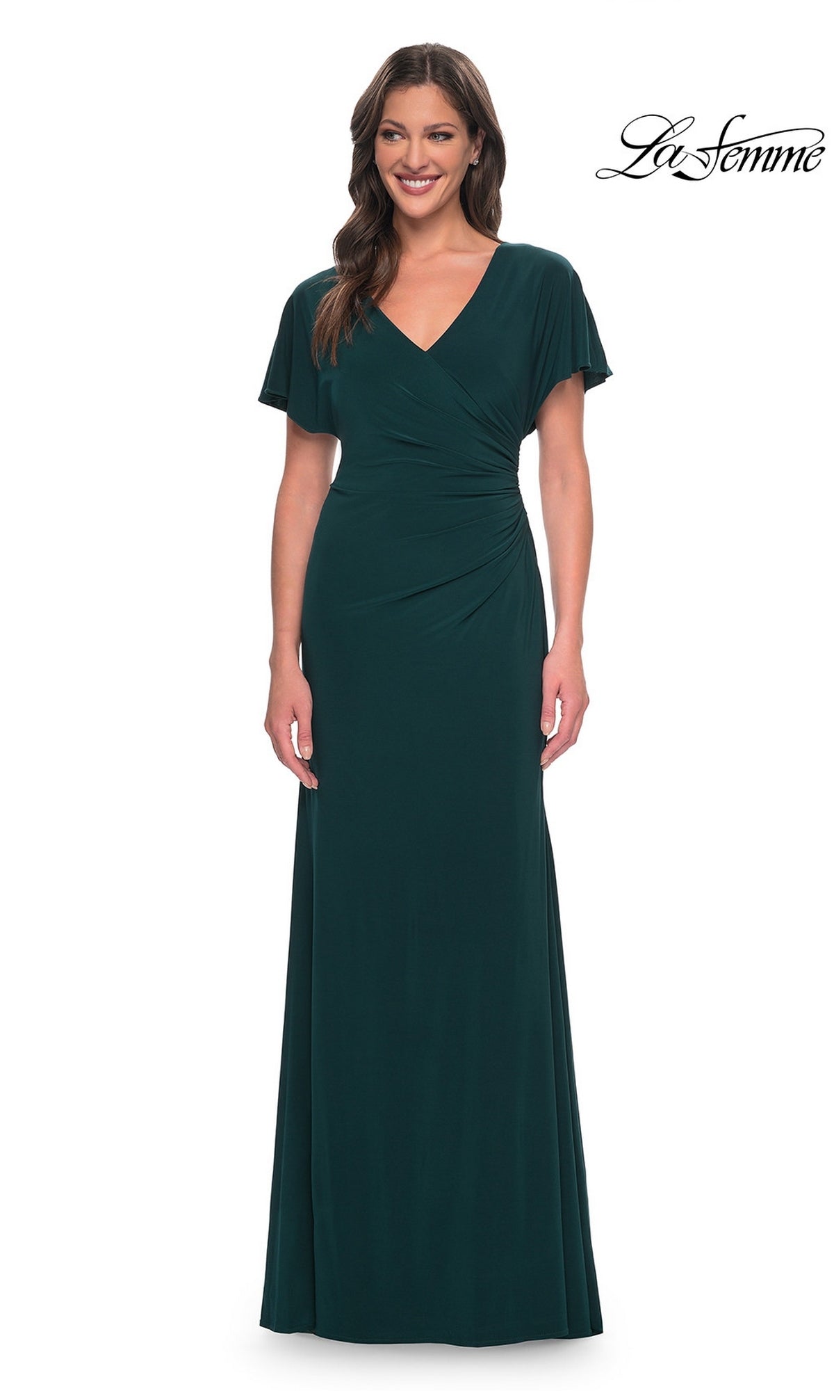 A woman wearing a hunter green Long Formal Dress: La Femme 29997 featuring a floor-length jersey design with short flutter sleeves and a V-neckline.