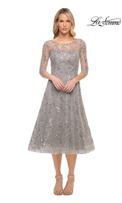 A woman wears a grey, fit-and-flare Midi Mother of Bride Dress: La Femme 30002 with three-quarter sleeves and all-over sequin embroidery, paired with neutral ankle-strap heels.
