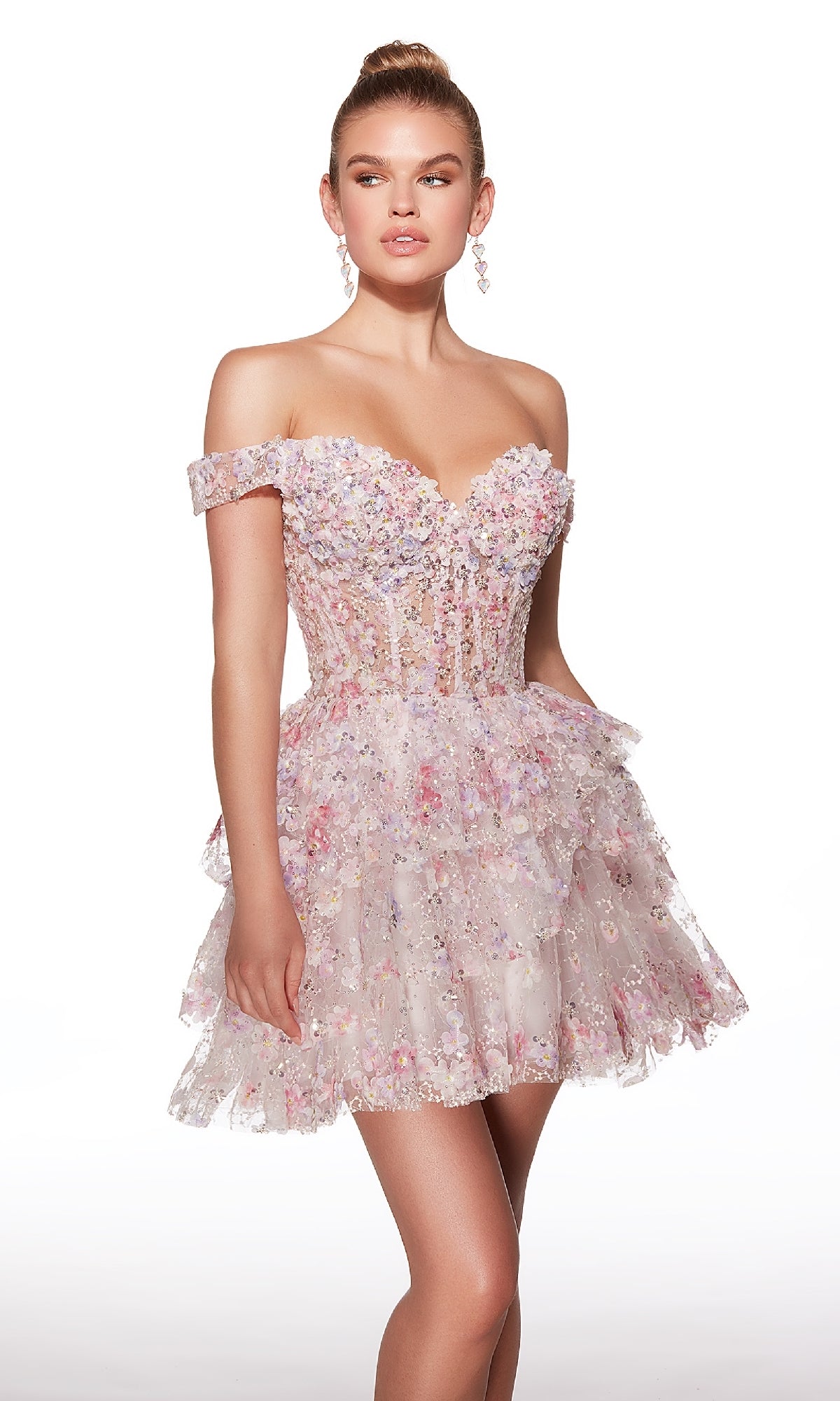 A woman wears the Alyce 30004 short homecoming dress, featuring an off-the-shoulder fit-and-flare silhouette with pastel floral patterns and a tiered ruffle skirt, posing against a plain white background.