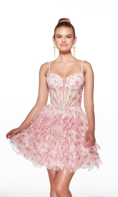 A woman poses against a plain white background wearing the Alyce 30009 short homecoming dress, featuring a light pink floral print, corset bodice, thin straps, and a flared skirt.